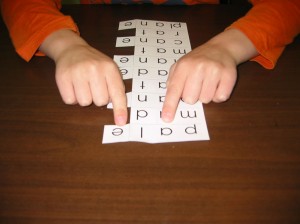 student uses both hands to point to talking vowel and silent-e
